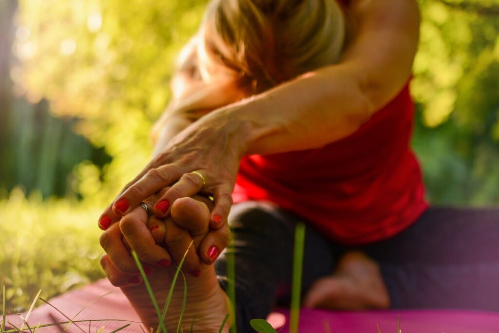 older woman stretching in a yoga pose