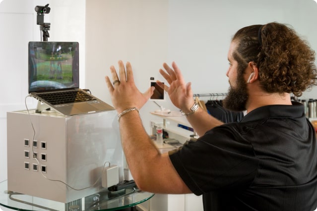 Personal trainer guiding a client through an online workout session.