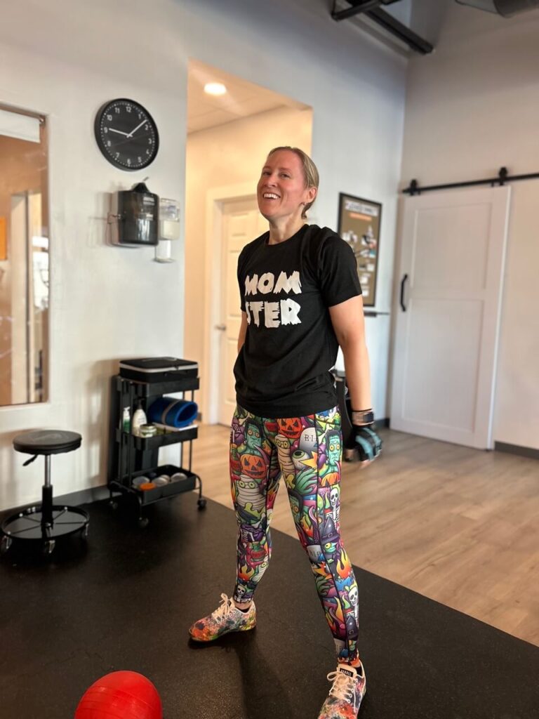 A happy young woman, smiling after completing her workout routine.