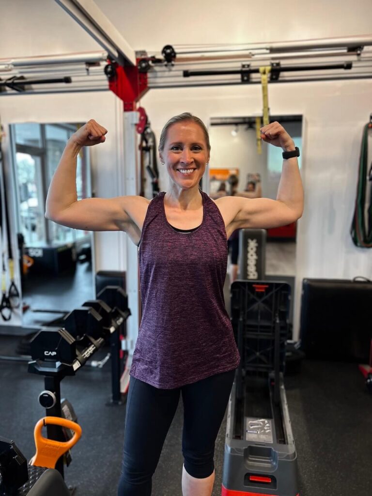 Elizabeth proudly flexing her muscles at Pledge To Fitness Studio in Houston, TX