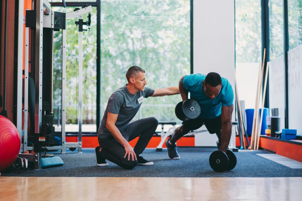 Personal training in Houston shown in a home setting: a trainer works one-on-one with a client, showcasing the flexible training options available in a large city.