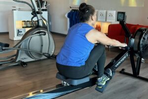 Woman exercising on row machine at Pledge to Fitness facility