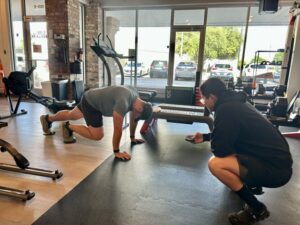 Dr. Collin Conrad demonstrating how fitness for busy professionals can fit into a demanding schedule through personalized training at Pledge To Fitness.